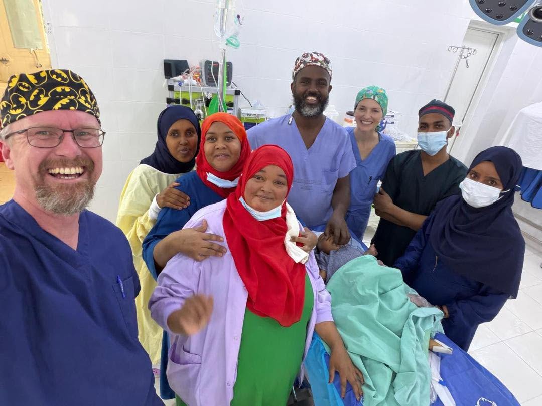 Somaliland clinicians and a visiting surgeon together in the operating room after a procedure